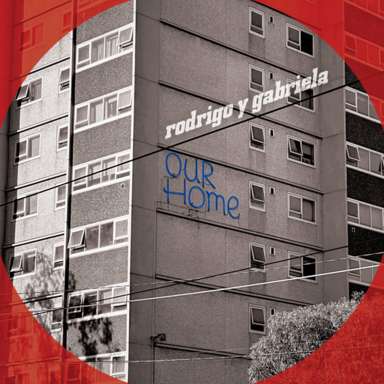 Album cover artwork for Our Home by Rodrigo y Gabriela featuring a monochrome high-rise apartment building framed inside a red circle.